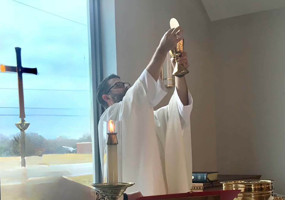 men studying and reading book of common prayer