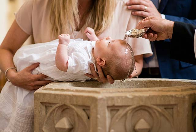 baby being baptized in a traditional Anglican church